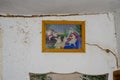 Religious icon in a village hut on a ruined wall. Consequences of the war