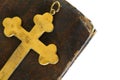 Religious items: old golden cross on an ancient Bible