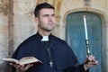 Religious man holding the Bible and a candle Royalty Free Stock Photo