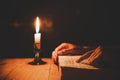 Religious man holding lit candles on the Holy Bible and praying in the Church, Royalty Free Stock Photo