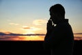 Religious man praying outdoors at sunset Royalty Free Stock Photo
