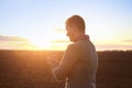 Religious man praying outdoors at sunset Royalty Free Stock Photo