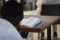 A religious man sitting and reading a torah at the Wailing Wall. Reading holy book of judaism at the western wall in Jerusalem old