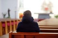 Religious middle age man praying and meditating in catholic church. Person begging for forgiveness and blessing from God Royalty Free Stock Photo