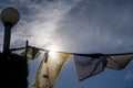 religious multicolored prayer flags old and tattered torn moving in the wind showing a bhuddist prayer incantation