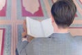 Religious muslim man praying inside the mosque and reading holy book koran