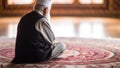 Religious muslim man praying at the mosque in the morning