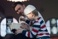 Religious Muslim Man teaching his little son to pray to God with Koran and rosary at mosque during ramadan Royalty Free Stock Photo