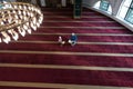 Religious Muslim Man teaching his little son to pray to God with Koran and rosary at mosque during ramadan Royalty Free Stock Photo