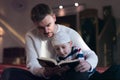 Religious Muslim Man teaching his little son to pray to God with Koran and rosary at mosque during ramadan Royalty Free Stock Photo