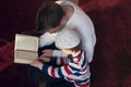 Religious Muslim Man teaching his little son to pray to God with Koran and rosary at mosque during ramadan Royalty Free Stock Photo