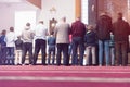 Religious muslim prayers praying together inside the big mosque