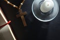 Religious nightstand to pray with Christian cross bible and candle