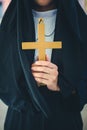 Religious nun in religion concept. Hands praying to the GOD while holding a crucifix symbol . Nun holding a cross in his hands. Royalty Free Stock Photo