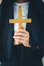 Religious nun in religion concept. Hands praying to the GOD while holding a crucifix symbol . Nun holding a cross in his hands. Royalty Free Stock Photo