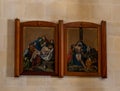 Religious paintings depicting the descent of Jesus from the cross painted on wood hang on the wall in the Saint Josephs Church in