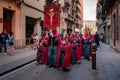 Adults and kids walking with costumes in a religious parade in holy week, Girona Spain Royalty Free Stock Photo