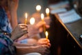 Lit candles in hands of religious people Royalty Free Stock Photo