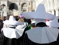religious procession with nuns wearing tunics and large white hats Royalty Free Stock Photo