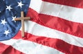 Religious right concept with Christian Wooden cross on American flag background Royalty Free Stock Photo