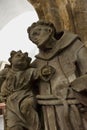 Religious sculpture of a monk and a child of the Ostroh Castle in Ostroh, Ukraine