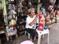 A religious shop owner fixes up a Child Jesus figurine