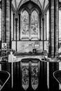 Religious stained glass windows reflected on fountain water surface inside Salisbury Cathedral