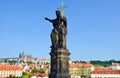 Religious statue on the edge of famous Charles Bridge in Prague, Czech Republic. Prague Castle and historical old town in Royalty Free Stock Photo