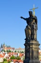 Religious statue pointing finger on famous Charles Bridge in Prague, Bohemia, Czech Republic. Prague Castle and historical center Royalty Free Stock Photo