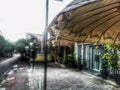 Religious symbolic umbrella on a street of an Indonesian city on a rainy day