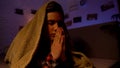 Religious teenager praying covered with blanket, belief in god, sectarianism Royalty Free Stock Photo