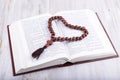 Religious theme holy book and cross on a white wooden background Royalty Free Stock Photo