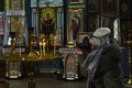 Ukraine, the village of Parkhomovka, Kharkiv region, February 8, 2020, a girl photographs candles in a church Royalty Free Stock Photo