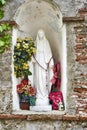 Religious Statue of Mary with Offerings of Worshipers in Form of