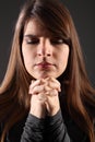 Religious woman eyes closed hands clasped praying Royalty Free Stock Photo