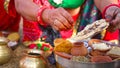 Religious woman offering sacred food to God on festival season in India. Hindu cultured woman praying outdoor