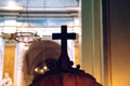 Religious wooden cross on a confessional in the dark interior of a Catholic church, with out of focus background Royalty Free Stock Photo
