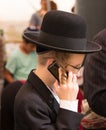 Religious young talking on his mobile phone