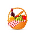 A relish wicker picnic basket with a bottle of red wine, fruit and cheese. Royalty Free Stock Photo