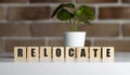 Relocate word. Wooden blocks with word Relocate. Business and Remortgage concept. Copy space. Royalty Free Stock Photo