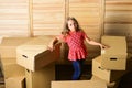 Relocating family can be exciting, but also stressful for kids. Kid girl relocating boxes background. Relocating concept