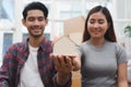 Relocation and beginning new life. Asian couple showing keys apartment after purchase and moving in new room together Royalty Free Stock Photo