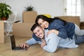 Relocation Concept. Happy Young Spouses Shopping Online On Laptop After Moving Home Royalty Free Stock Photo