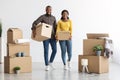 Relocation Concept. Portrait Of Cheerful Black Spouses Moving To New Apartment Royalty Free Stock Photo