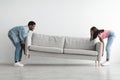 Happy black couple replacing furniture in their new apartment Royalty Free Stock Photo