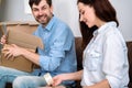 Happy young couple packing belonging in cardboard boxes Royalty Free Stock Photo