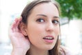 Relying on hand-ear listening young woman
