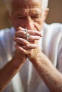 Relying on his faith to see him through. Cropped shot an elderly man holding a rosary in prayer. Royalty Free Stock Photo