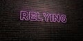 RELYING -Realistic Neon Sign on Brick Wall background - 3D rendered royalty free stock image