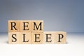 Rem sleep text from wooden cubes. Photo was taken in white background